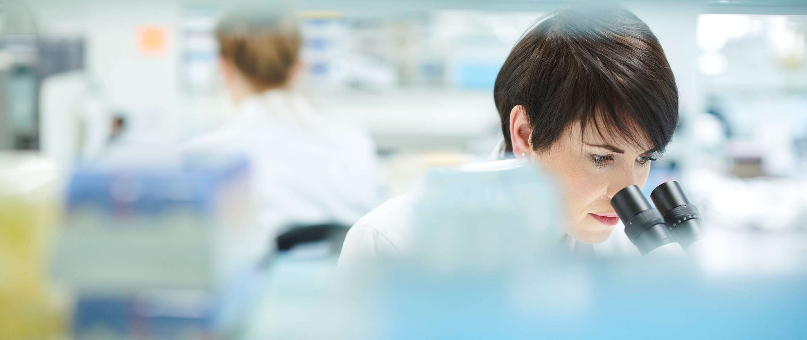 Female looking into microscope