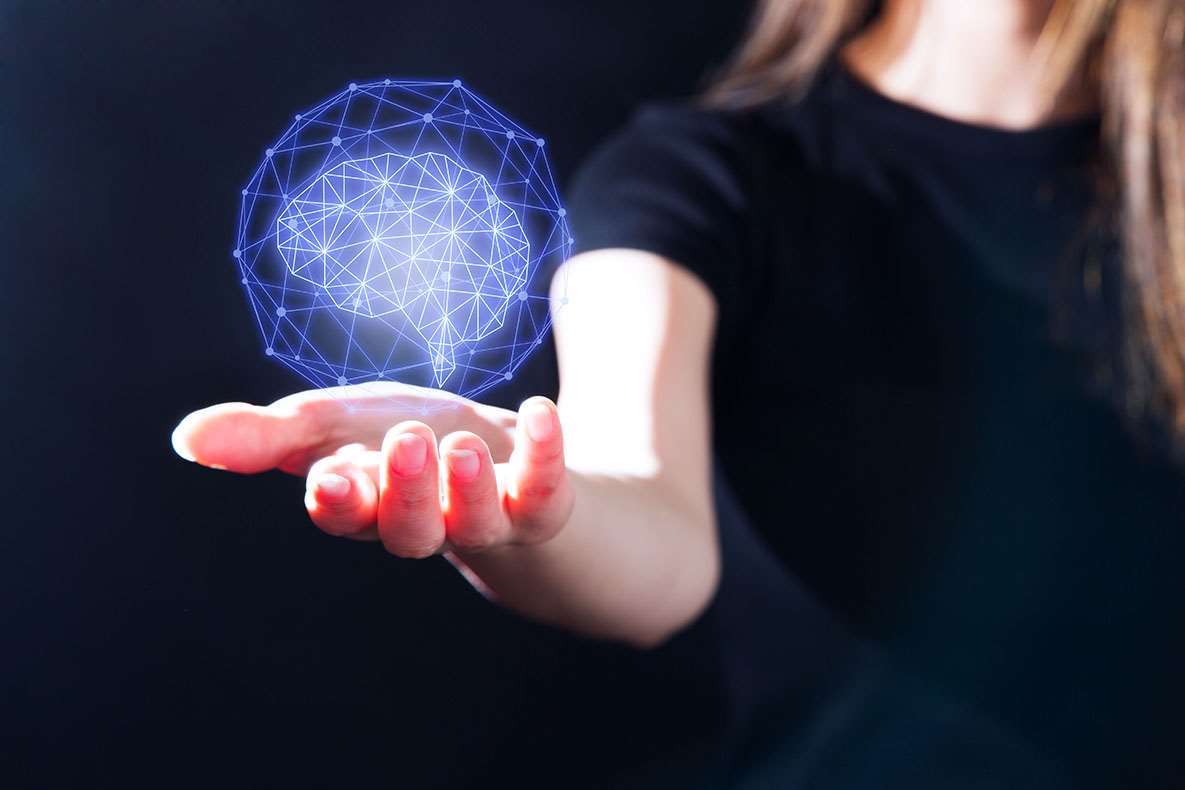 Science model globe shape suspended above hand