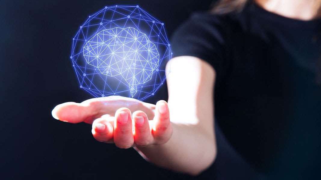 Science model globe shape suspended above hand