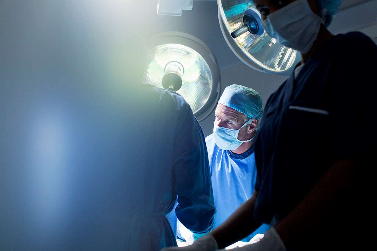 Surgeon in operating room backlighting