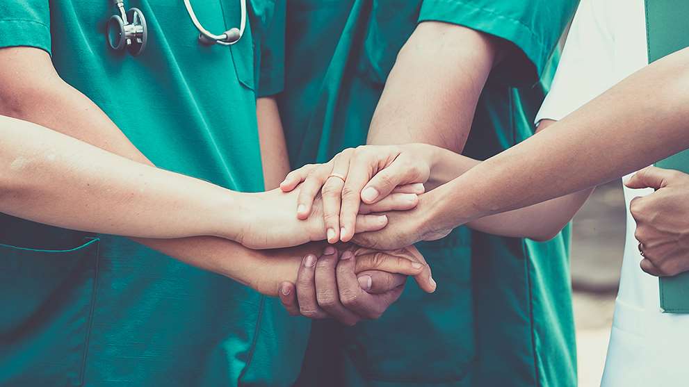 Surgical team hands together