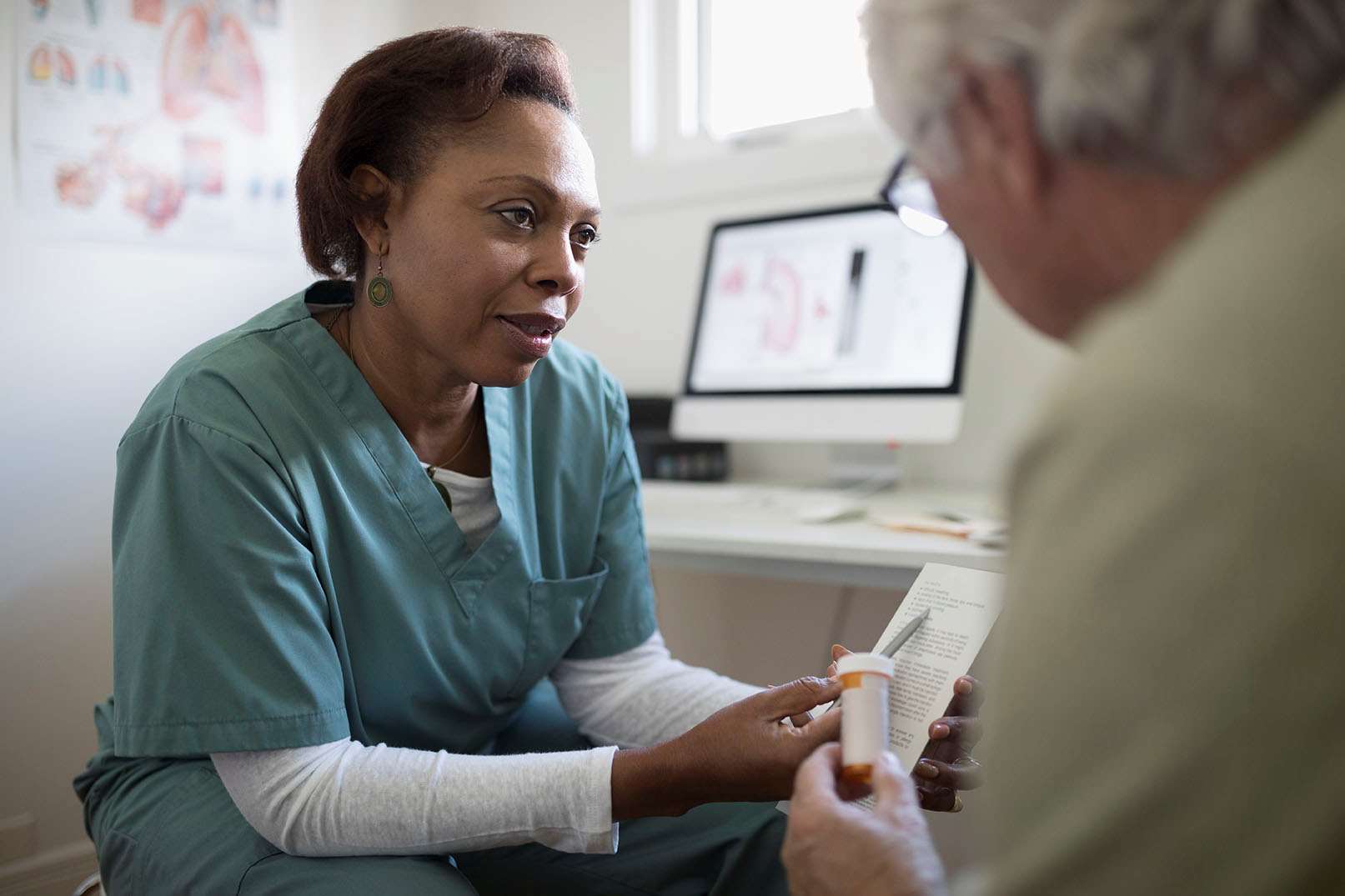 Care team explains prescription to patient