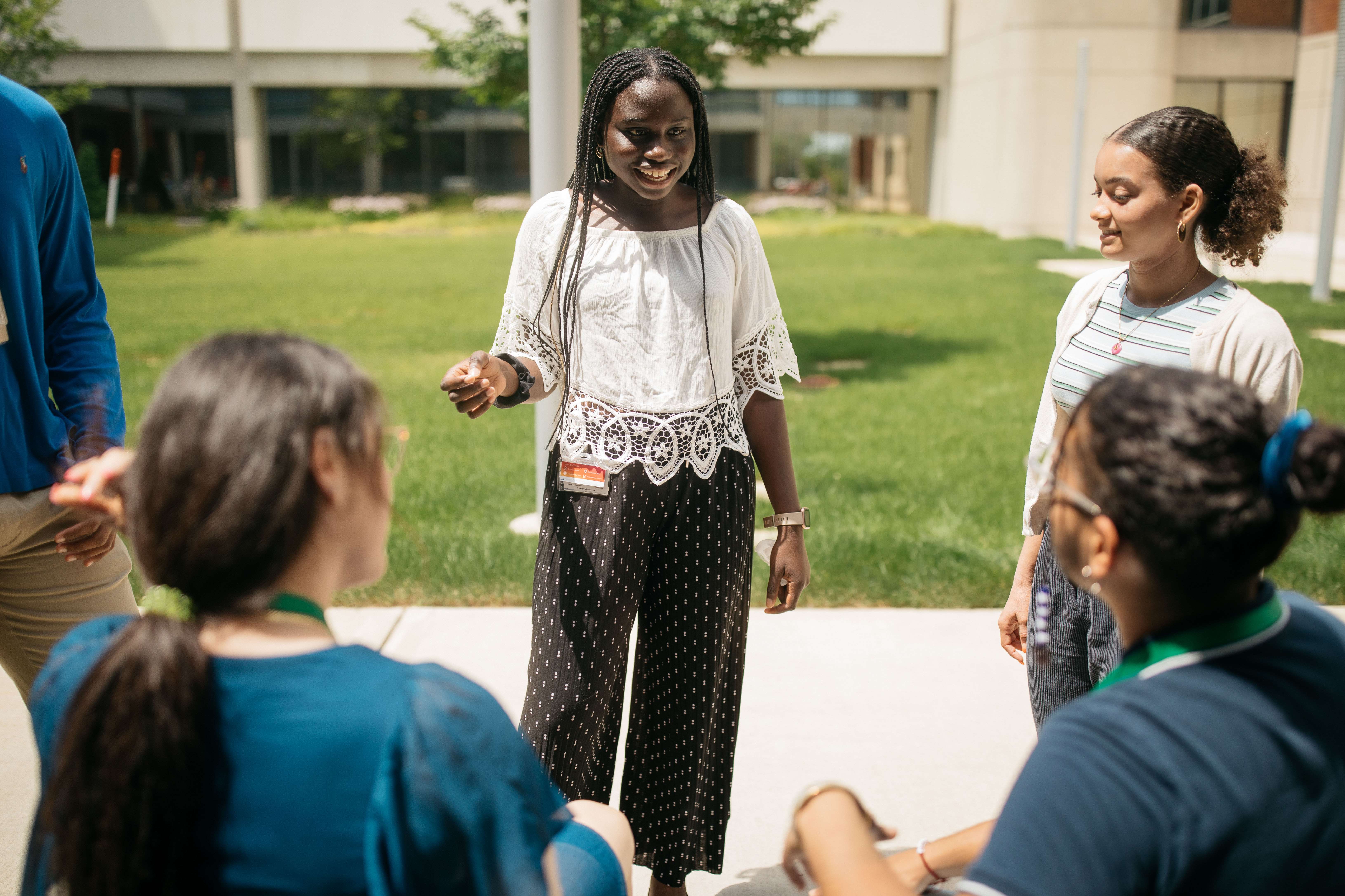 female students talking outside in courtyard