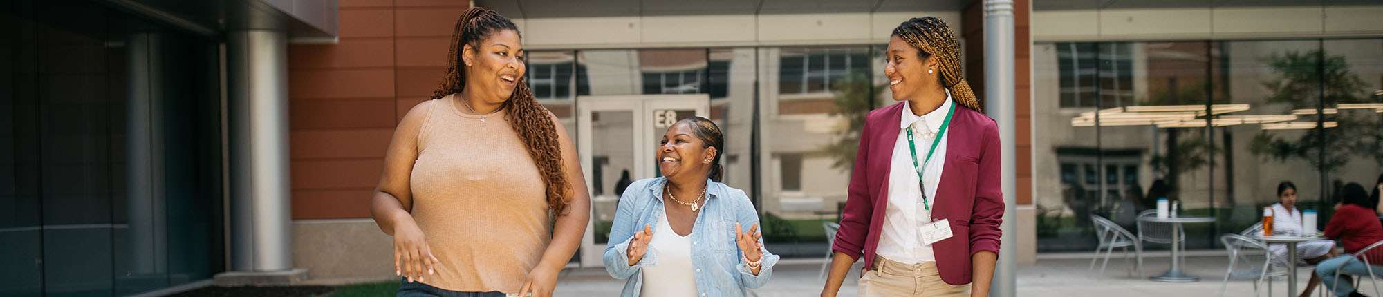 female students talking outside in courtyard