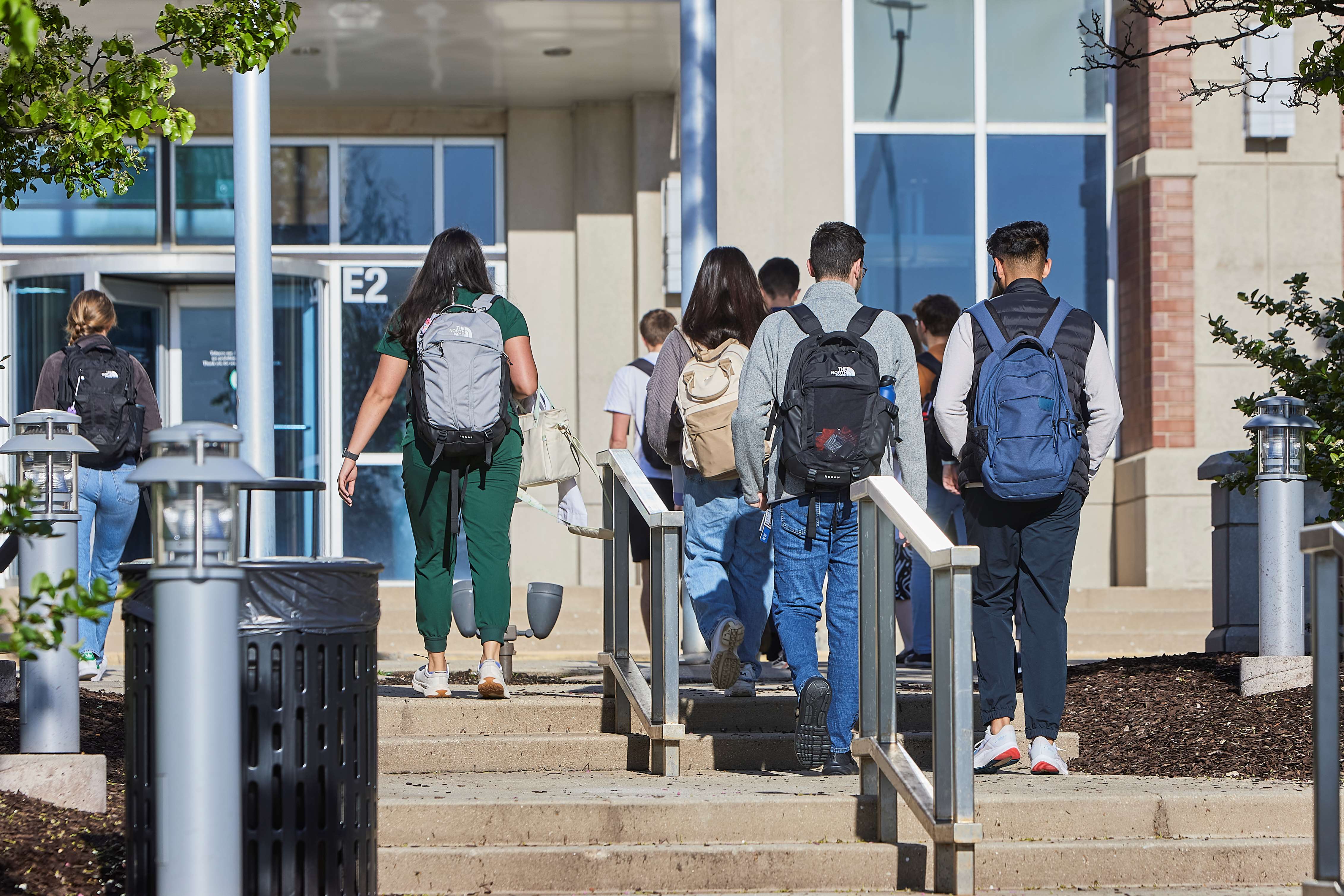 Group of medical students walking into the MCW entrance.