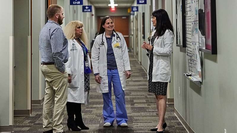 Health care providers talking in hallway