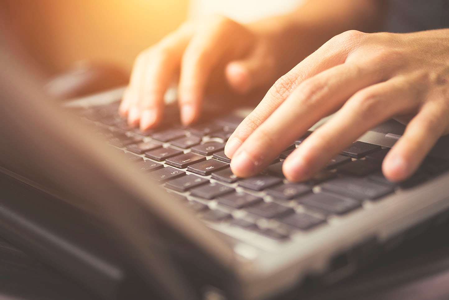 Hands on laptop keyboard