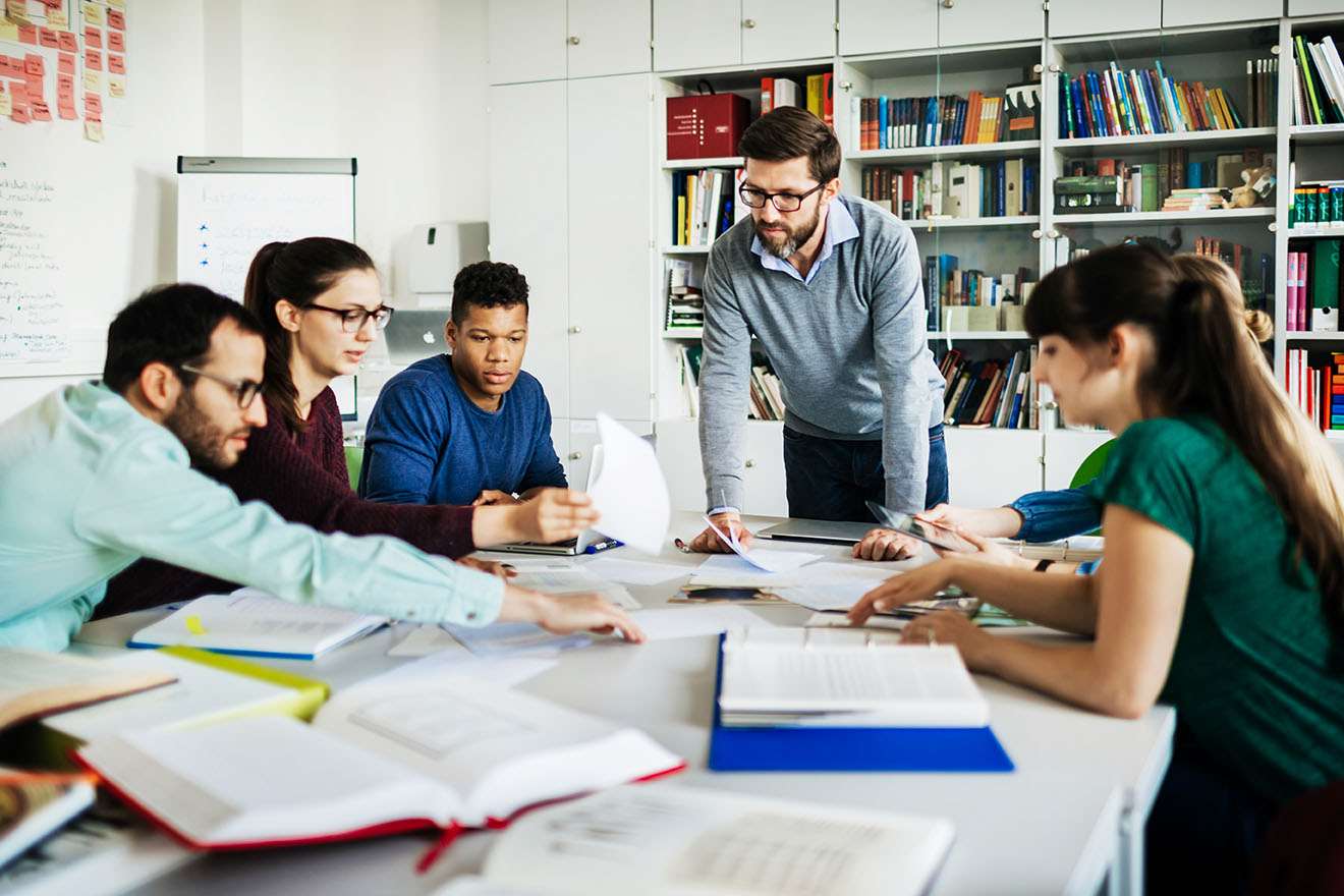 Team studies books on table