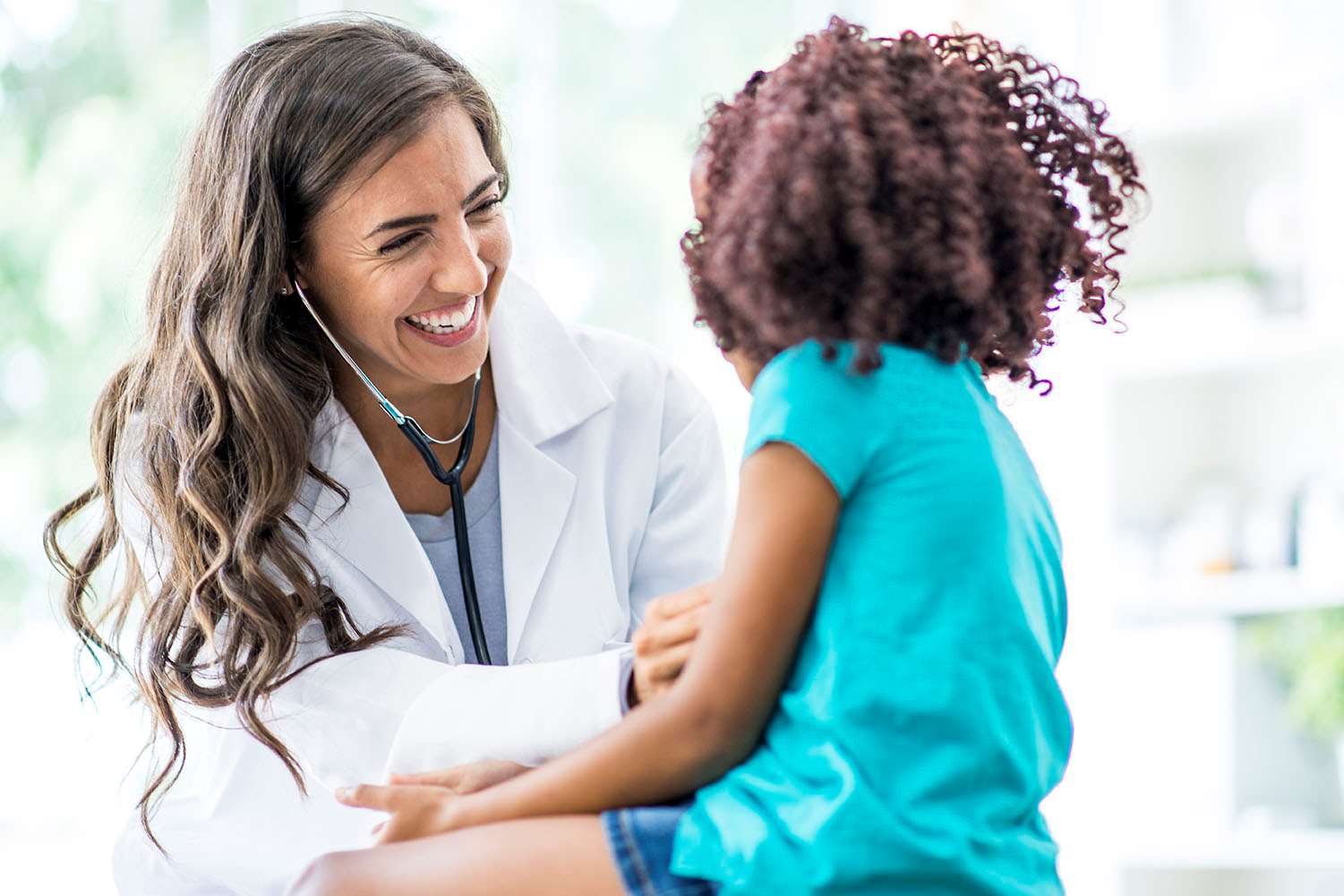 Physician examining young female