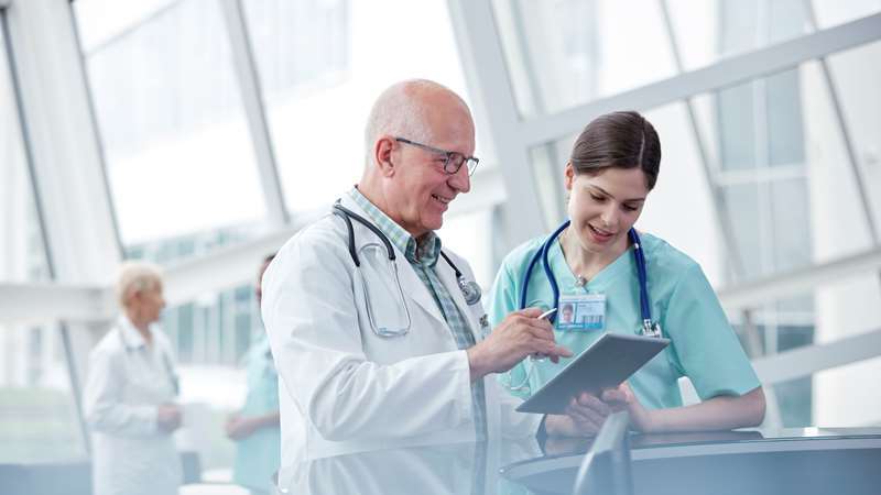 Doctors Consulting around Tablet