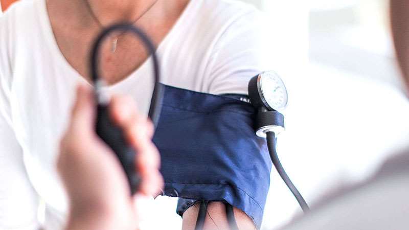 Woman having blood pressure reading taken