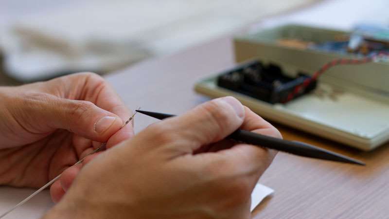 Researcher working with electrode in ReyLab