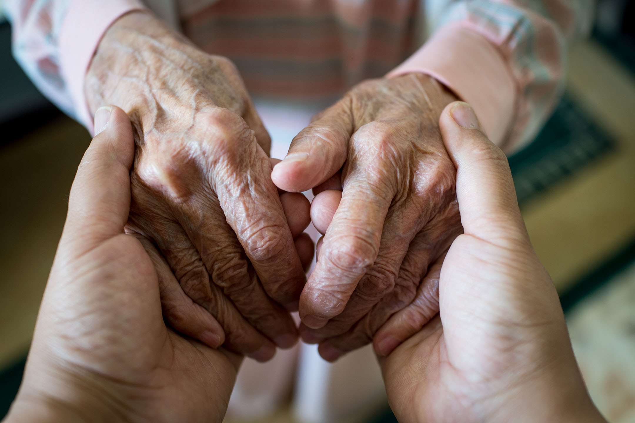 Mature adult hands set in second set of hands